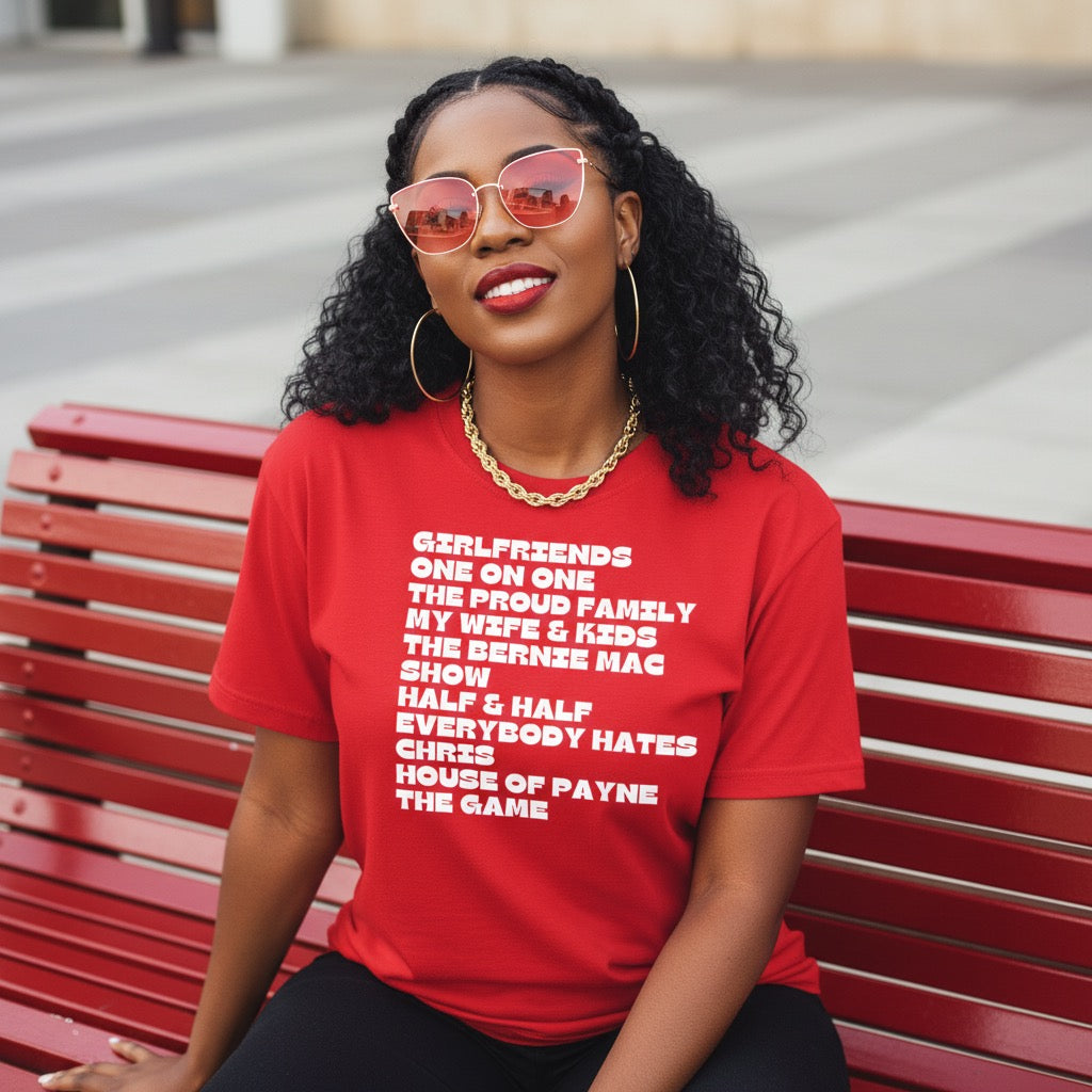 Woman wearing a red t-shirt with text sitting on a red bench.