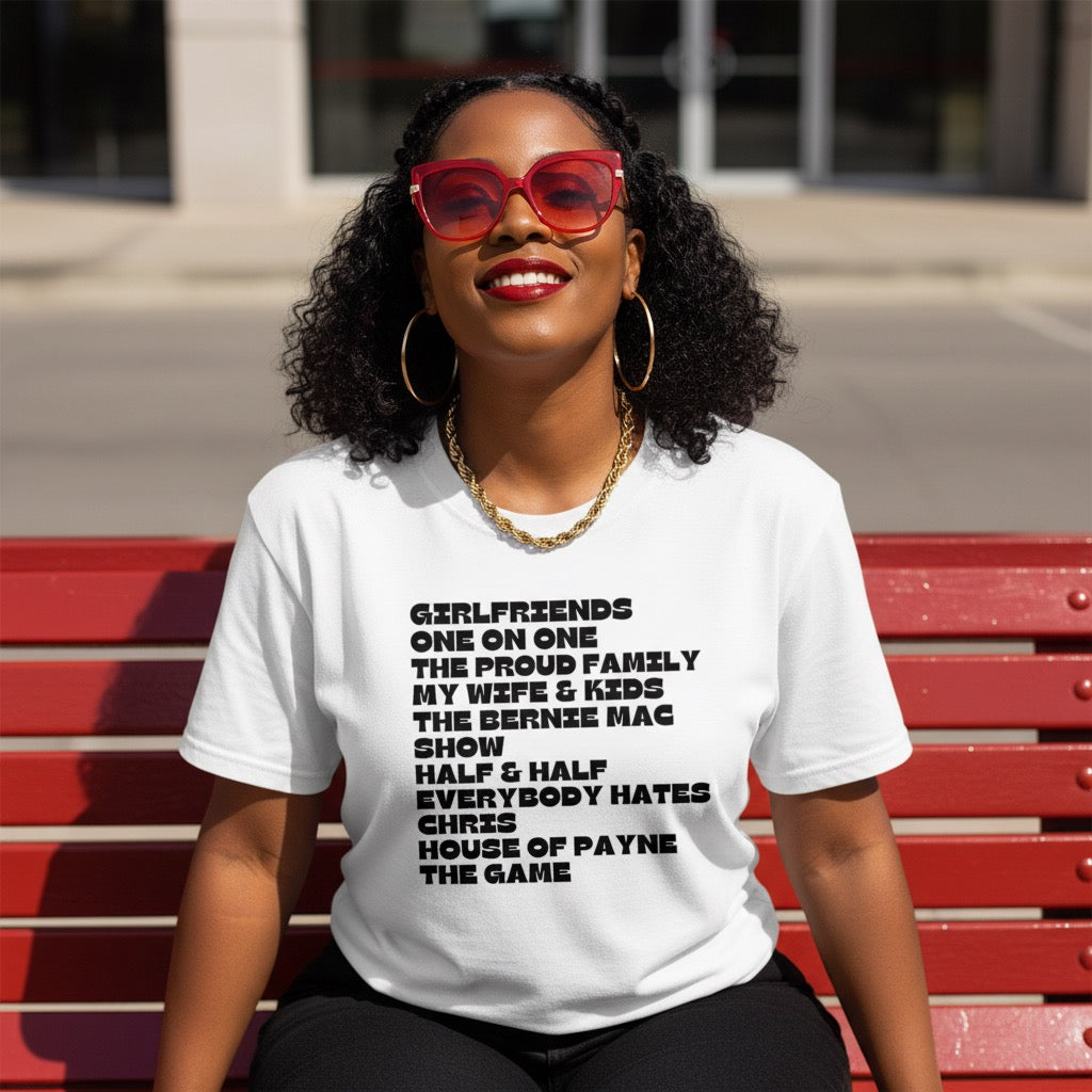 Woman wearing a white t-shirt with text, sitting on a red bench.