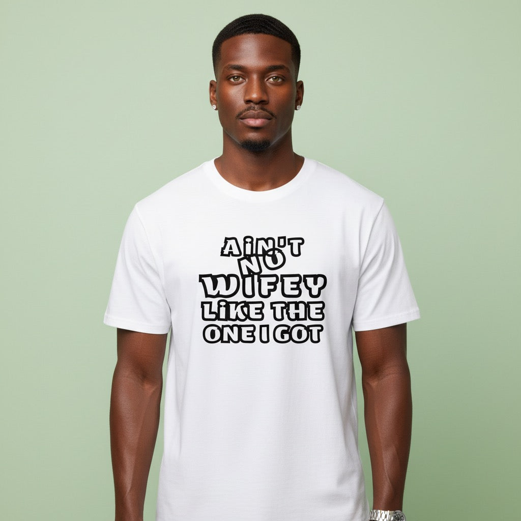 Man wearing a white t-shirt with text on a green background