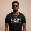 Man wearing a black t-shirt with 'ALREADY HANDLED' text on a beige background
