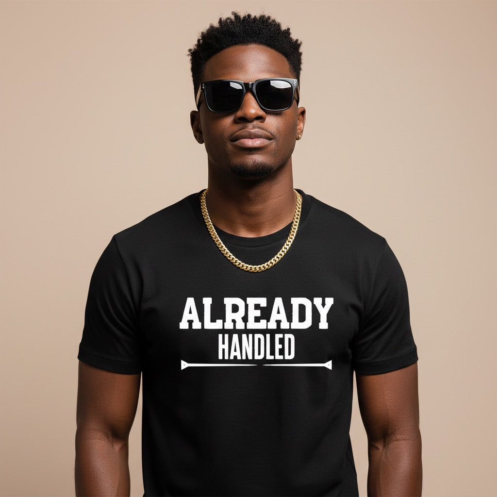 Man wearing a black t-shirt with 'ALREADY HANDLED' text on a beige background