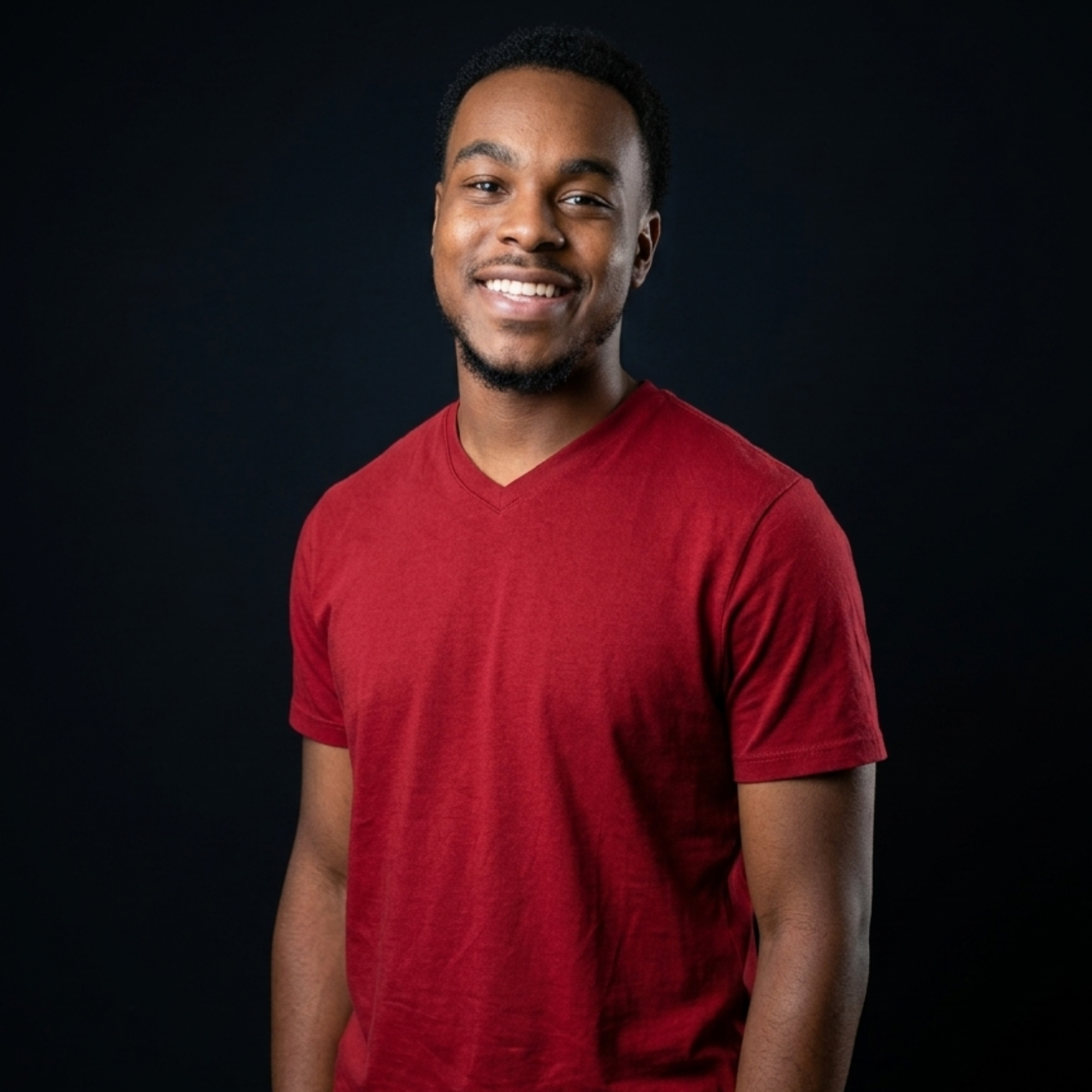 Xavier wearing a red shirt against a black background