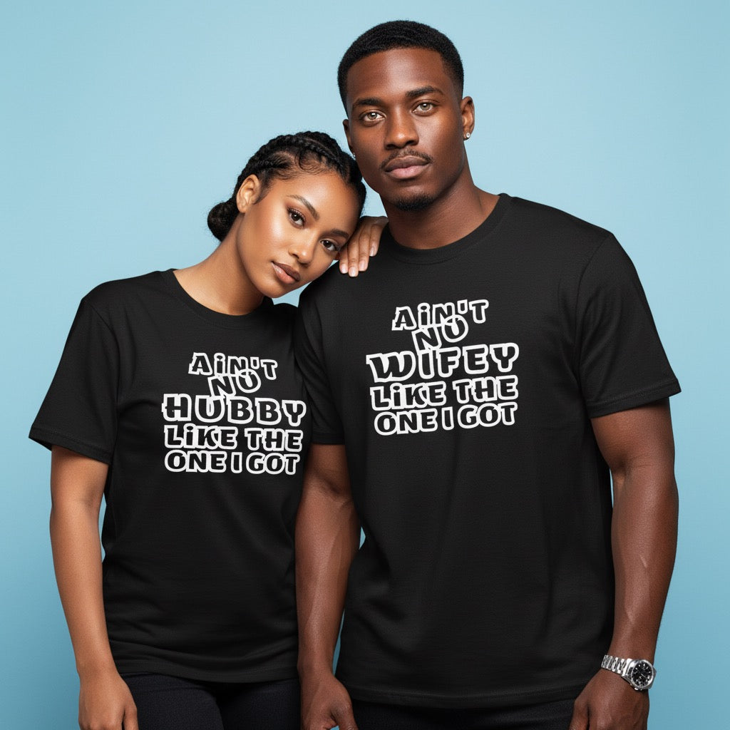 Two people wearing black t-shirts with humorous text designs on a blue background