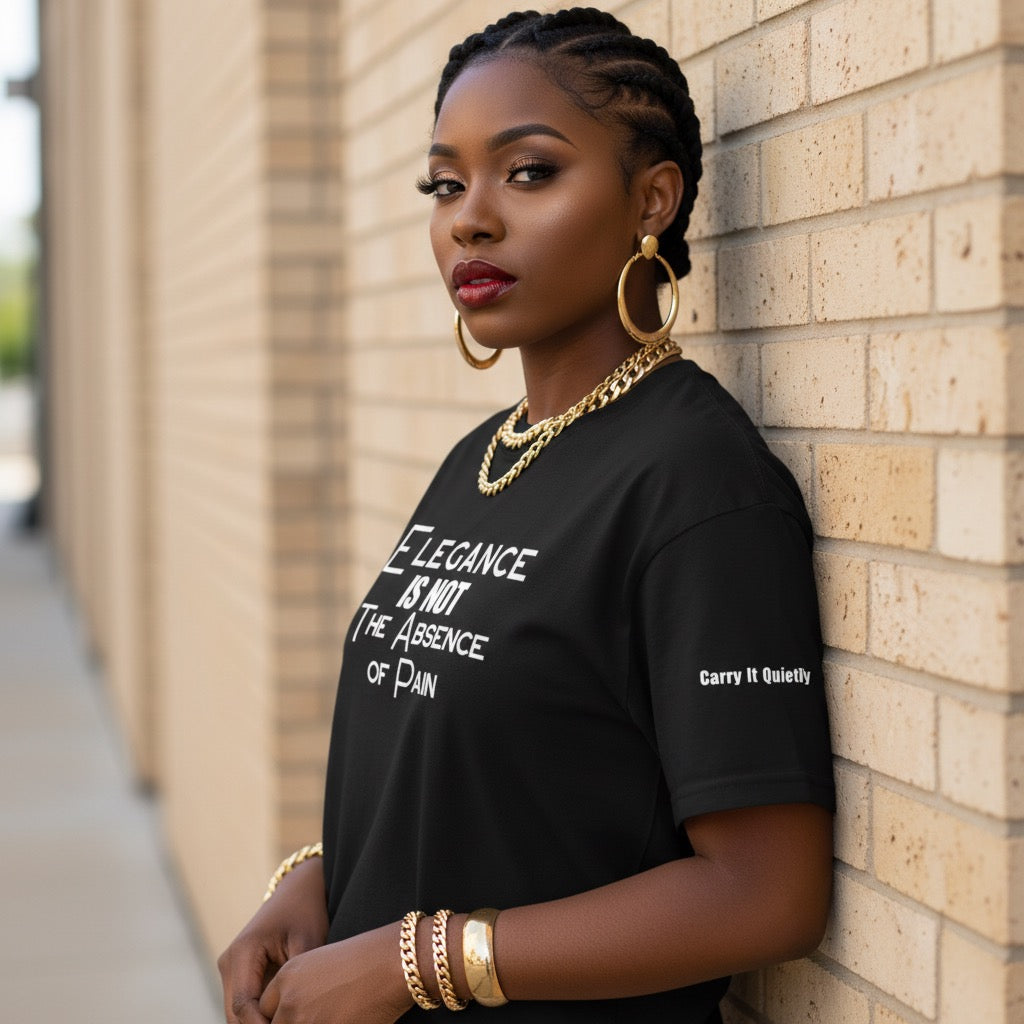 Woman wearing a black t-shirt with text, leaning against a brick wall.