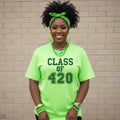 Person wearing a bright green 'CLASS OF 420' t-shirt against a brick wall.