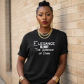Woman wearing a black t-shirt with a quote, standing against a brick wall.