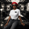 Woman in a stylish outfit with a white t-shirt and red beret in an elegant interior setting.