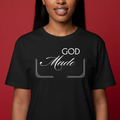 Person wearing a black t-shirt with 'GOD Made' text on a red background