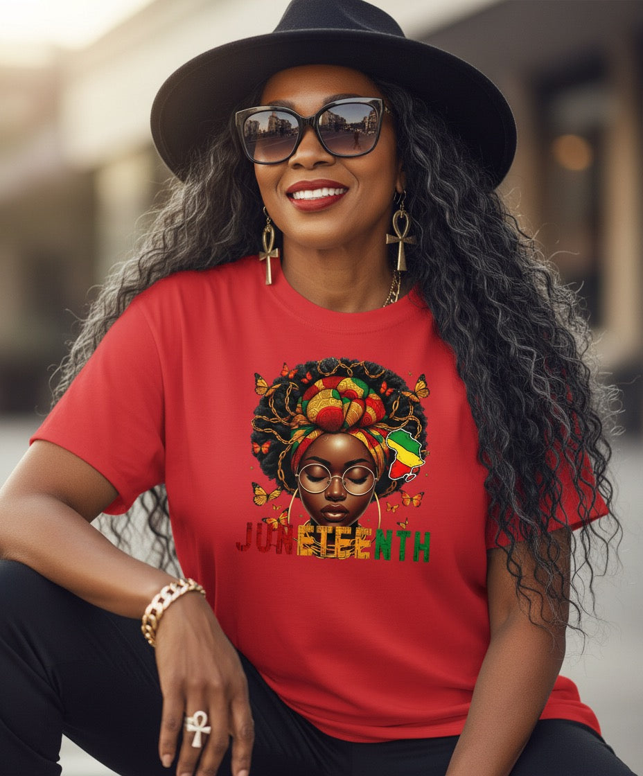 Woman wearing a red t-shirt with a colorful graphic and text, sitting outdoors.