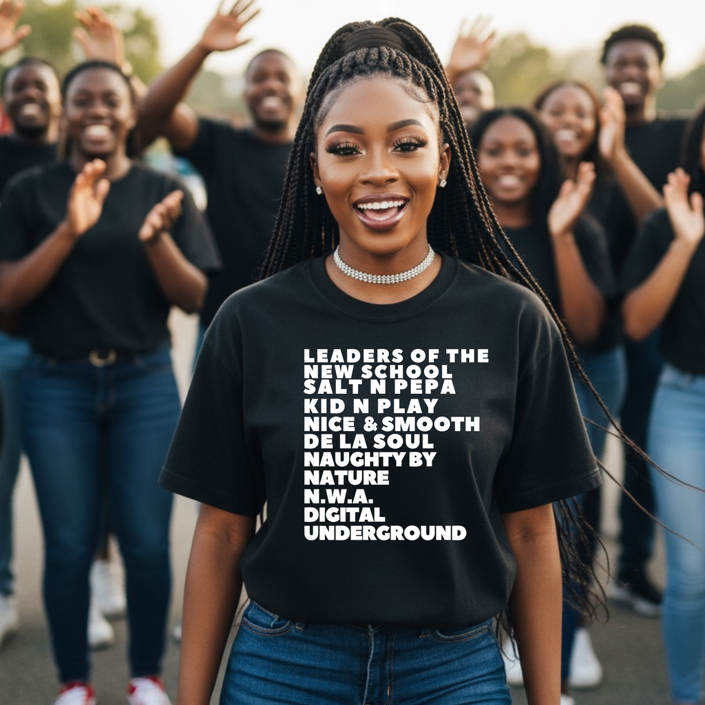 Woman wearing a black t-shirt with text, standing in front of a group of people.