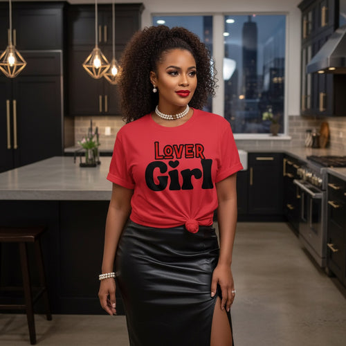 Woman wearing a red 'Lover Girl' t-shirt in a modern kitchen.