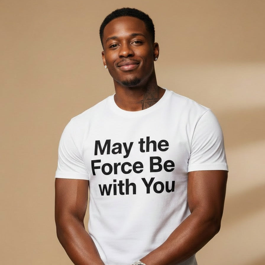Man wearing a white t-shirt with 'May the Force Be With You' text on a beige background