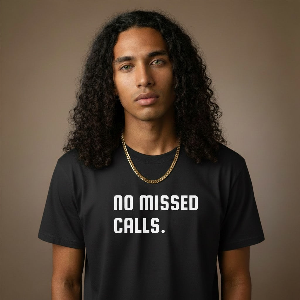 Person wearing a black t-shirt with 'NO MISSED CALLS.' text on a brown background