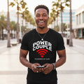 Man wearing a black t-shirt with 'Power Couple' text, standing outdoors with palm trees in the background.