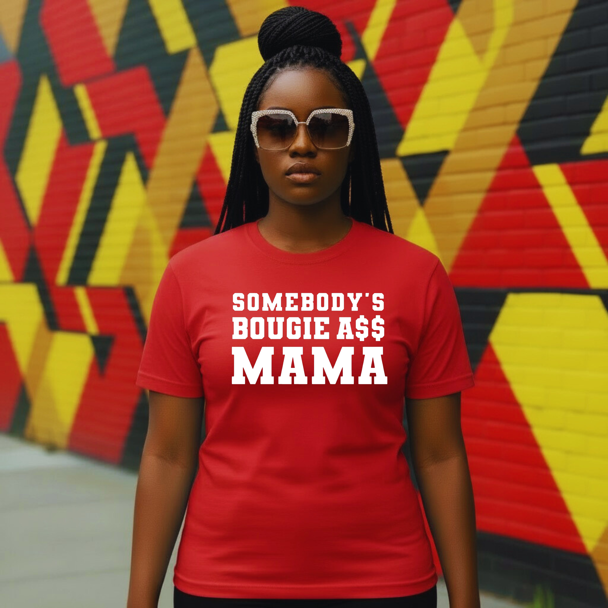 Woman in red graphic t-shirt with 'Somebody's Bougie A$$ Mama' text, urban mural background