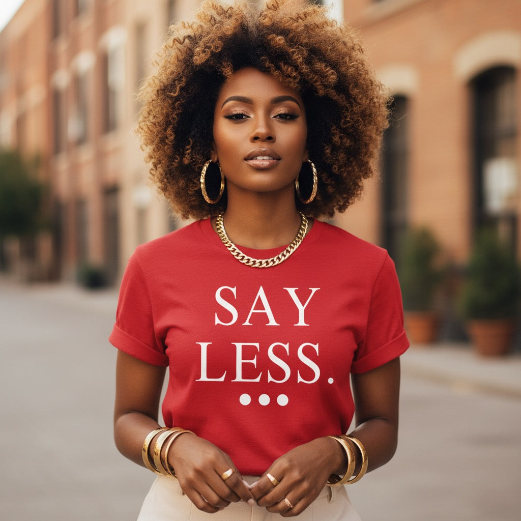 Woman wearing a red t-shirt with 'SAY LESS' text on a street background