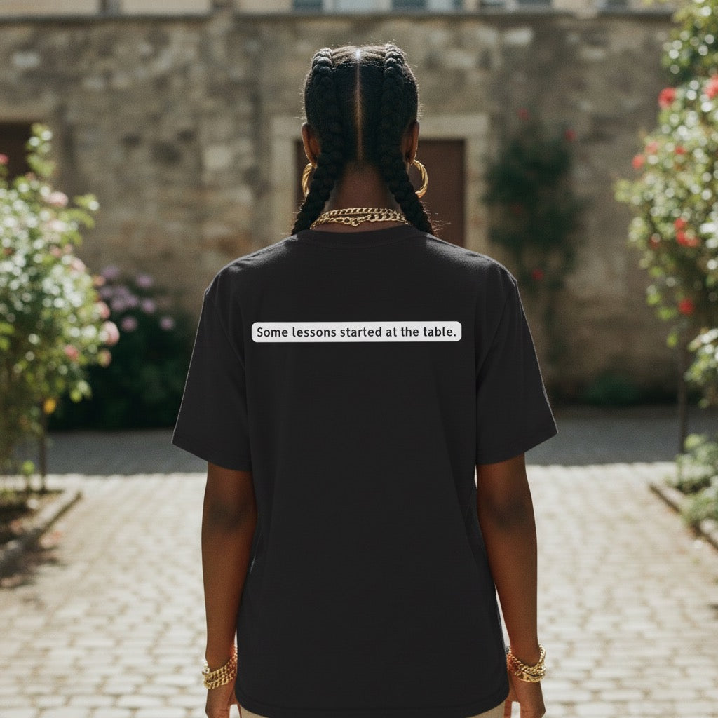 Black woman wearing “Some lessons start at the table” cultural statement apparel by Legacy 4 Xavier
