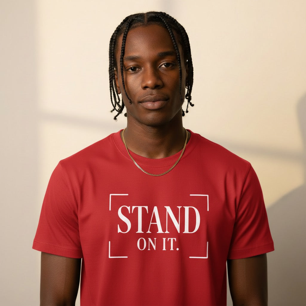 Person wearing a red t-shirt with 'STAND ON IT.' text on a beige background
