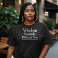 Black shirt featuring “Wisdom Sounds Different Now” statement typography