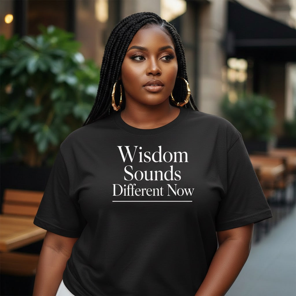 Black shirt featuring “Wisdom Sounds Different Now” statement typography