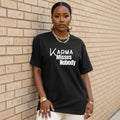 Black unisex statement t-shirt reading “Karma Misses Nobody” in bold minimal typography