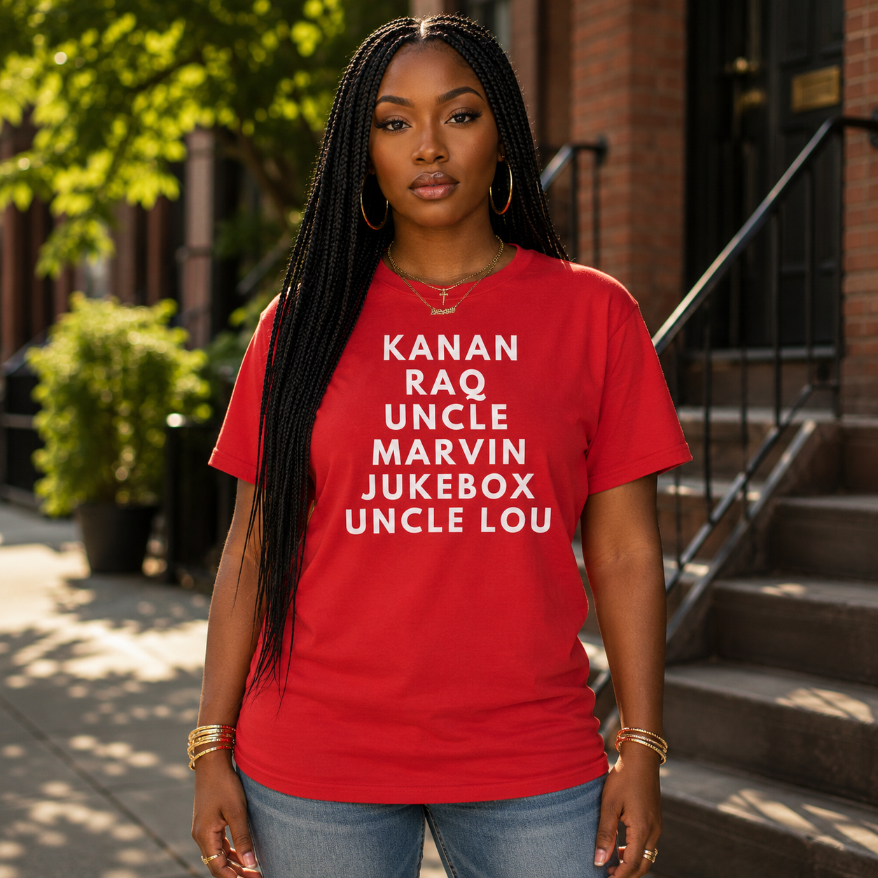 Black woman wearing the Raising Kanan Family Roll Call graphic tee in red with white typography.